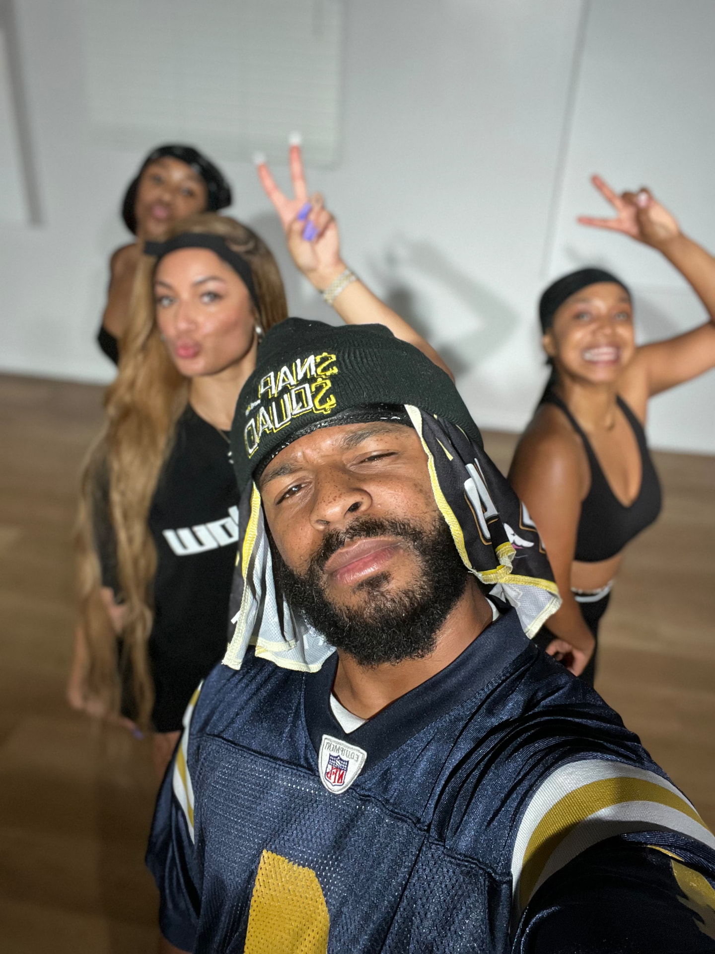 Taiwan Williams in a $NAP$QUAD beanie leading dancers in the studio